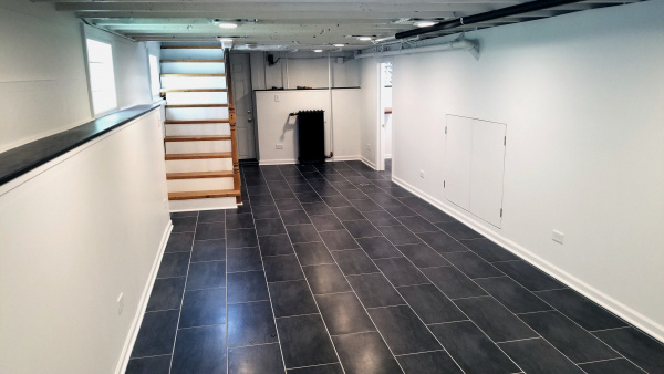 Renovated basement with open joists ceiling
