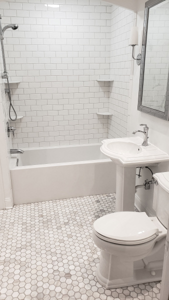 Bathroom after renovation in white-gray ton with marble floor tiles